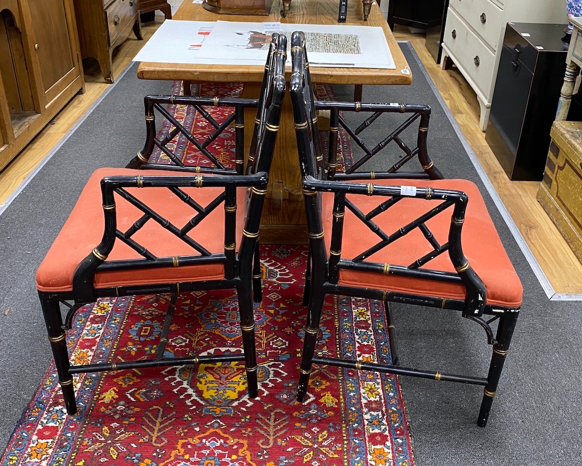 A pair of Regency style lacquer lattice back elbow chairs (one a.f.), width 56cm, depth 49cm, height 94cm